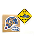 Die-cut vinyl sticker of a shark warning sign that reads: "scoff zone - just saying"